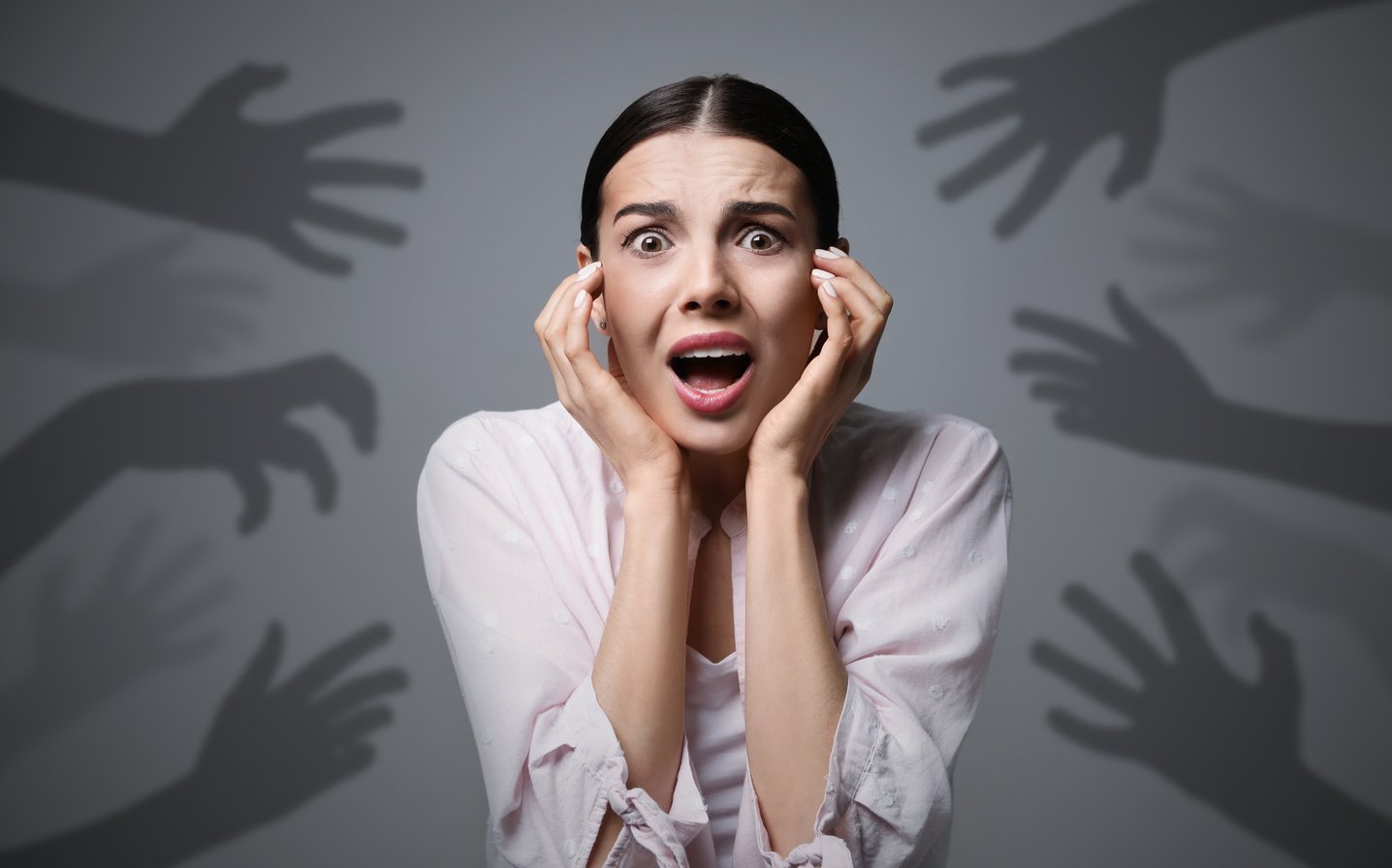 Young Woman Feeling Fear on Grey Background